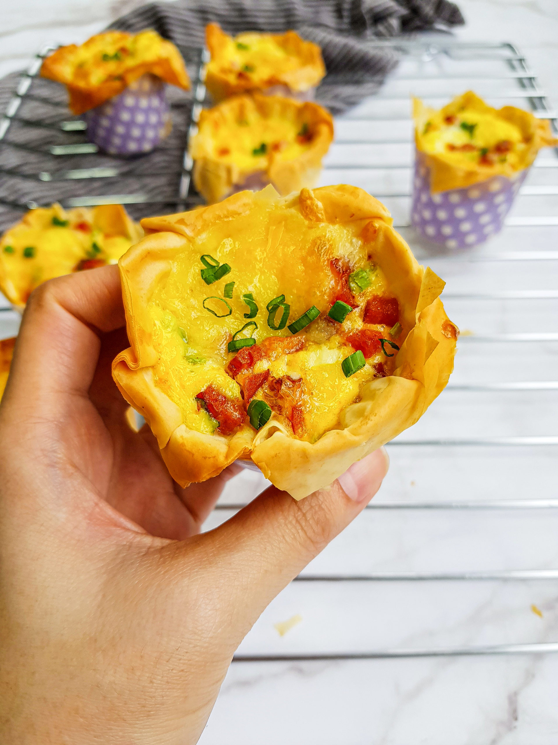 These mini quiches are made with flaky phyllo dough, savory sausage, and sharp cheddar cheese, and are easy to make for a delicious breakfast or brunch.