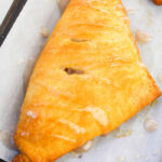 Flaky apple turnovers filled with spiced apple mixture, drizzled with icing