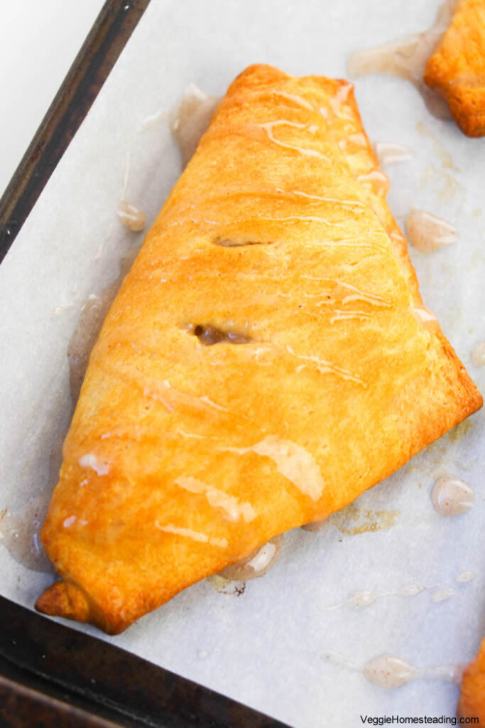 Flaky apple turnovers filled with spiced apple mixture, drizzled with icing